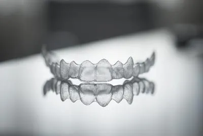 Invisalign clear aligners on a glass table