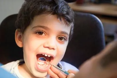 young patient receiving a dental checkup at AZ Dental