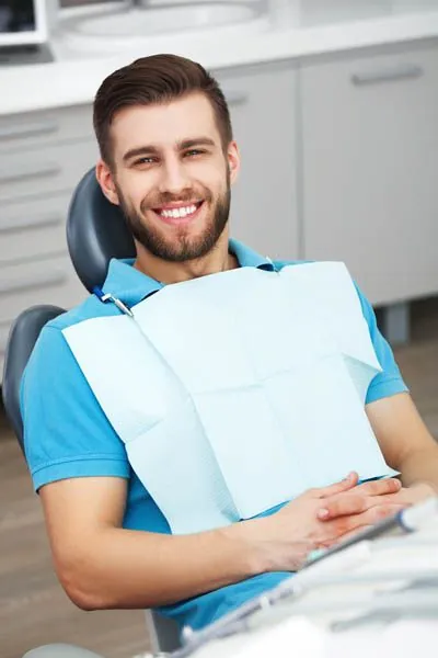 man smiling after dental bonding helped restore his smile